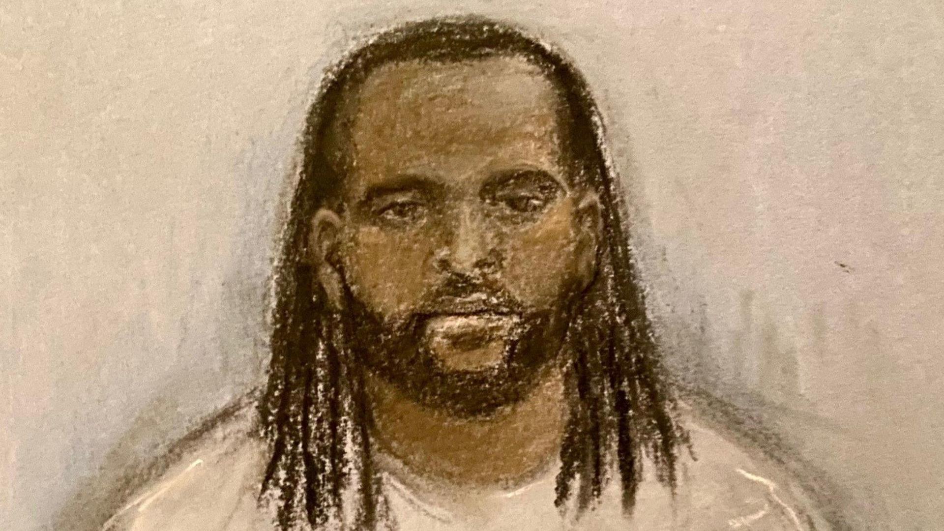 Court sketch of Jay Emmanuel-Thomas in prison. His hair is braided and he has a beard. He is wearing a white crew-neck shirt.