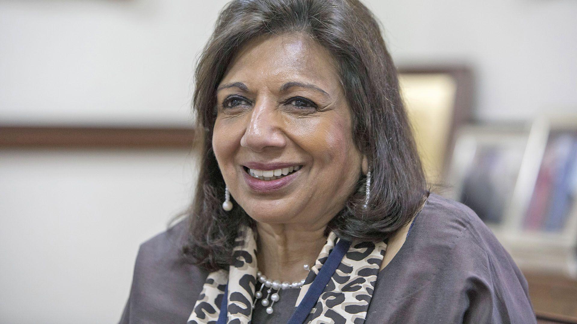 Kiran Mazumdar-Shaw, wearing a pearl necklace, smiles during an interview