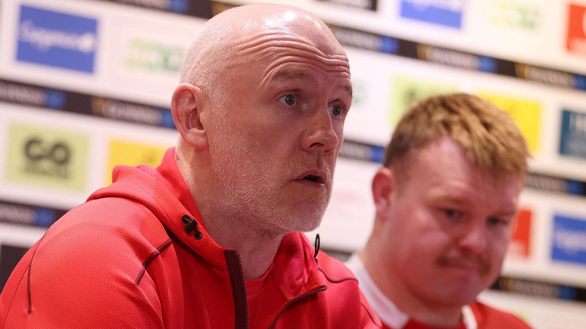 Wales head coach Steve Tandy speaks at a media conference with captain Dewi Lake in the background