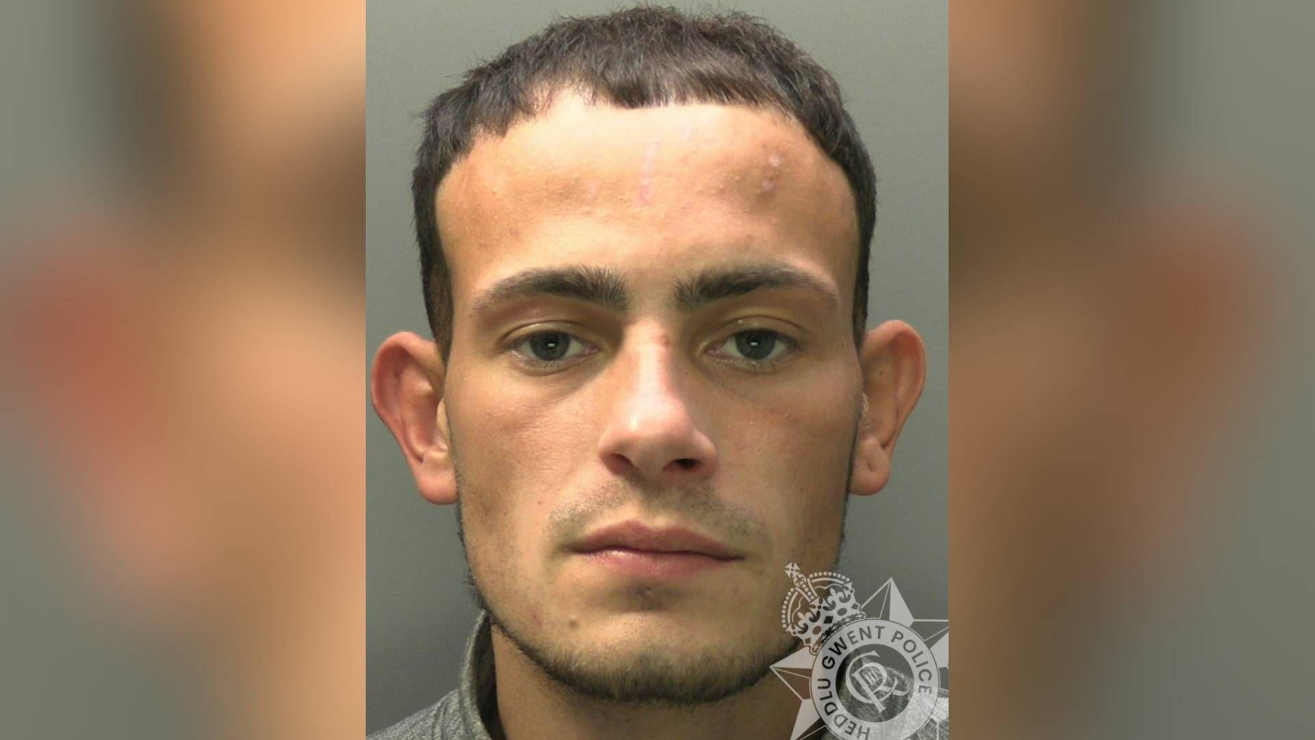 Custody pic of Harri Pullen. He was brown short hair, brown eyes and a brown short beard.