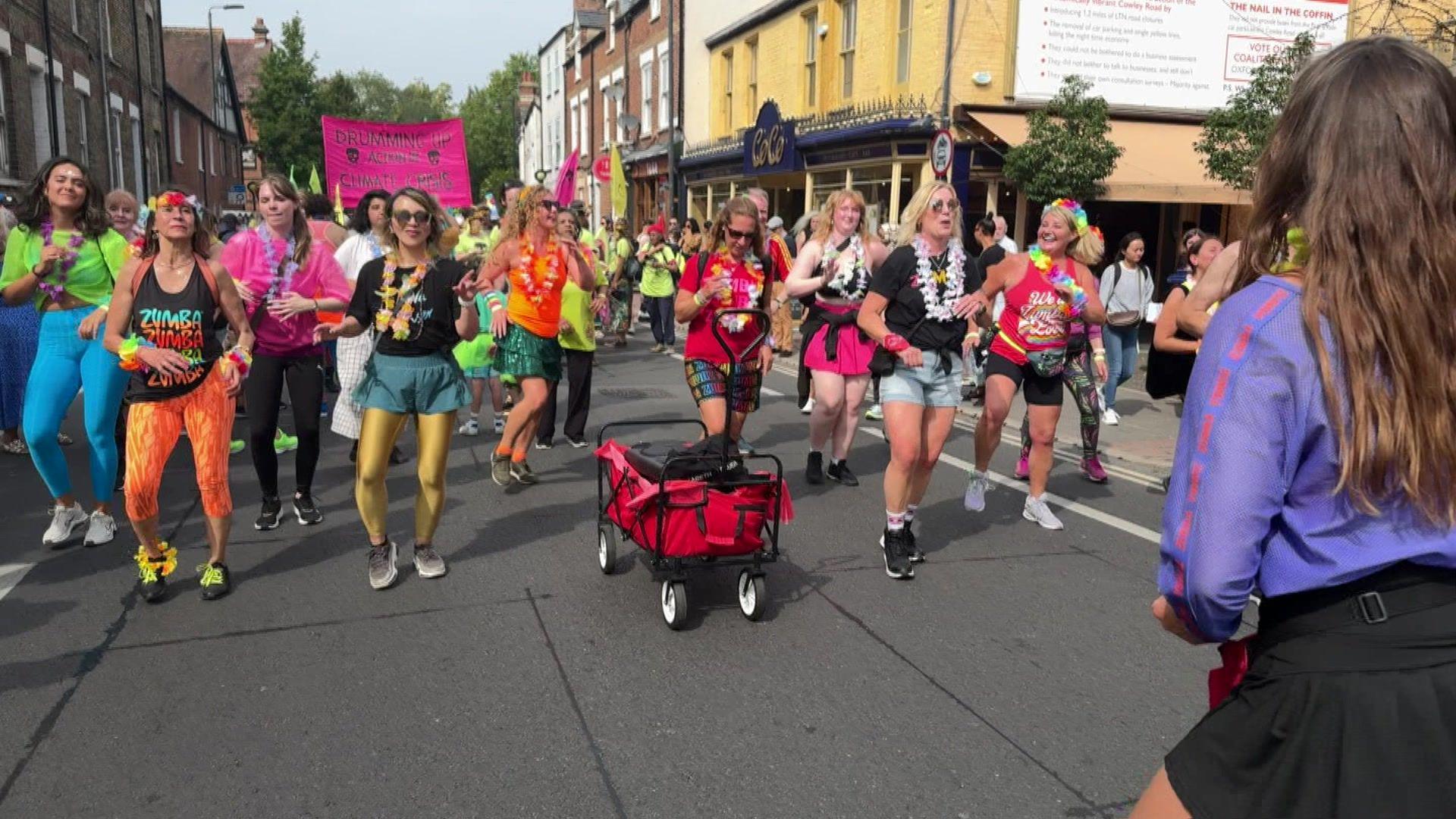 A group of zumba exercisers marching as part of the parade. 