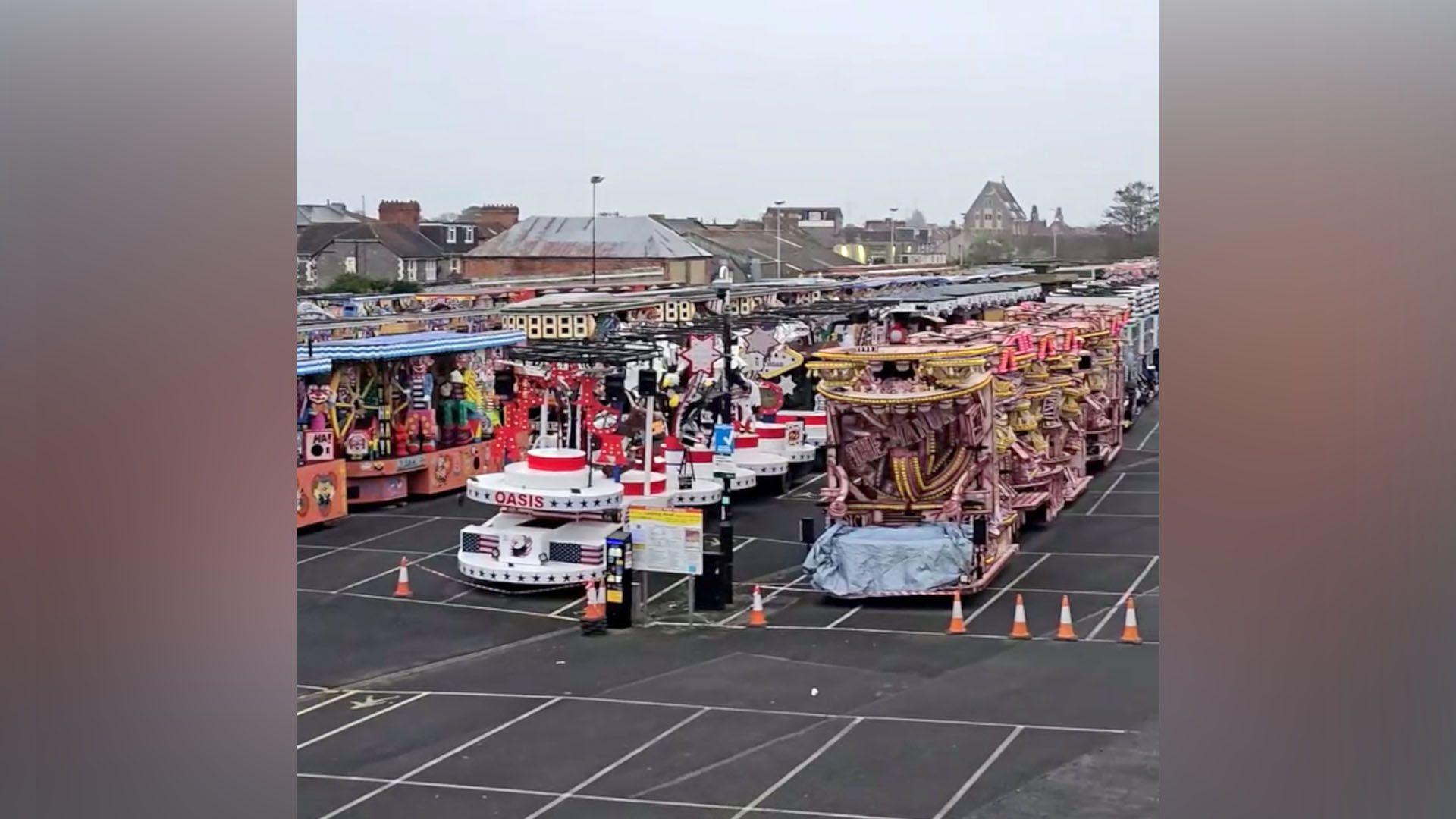 Carnival carts lined-up in a car park.