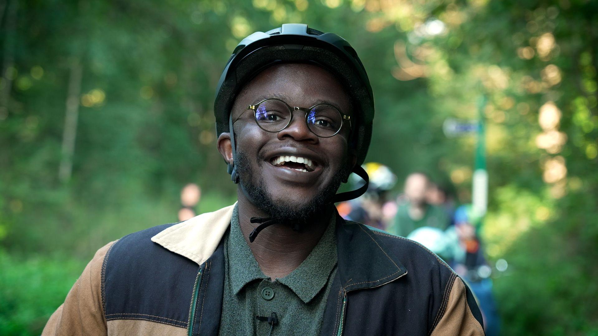 de-graft smiling wearing a bike helmet