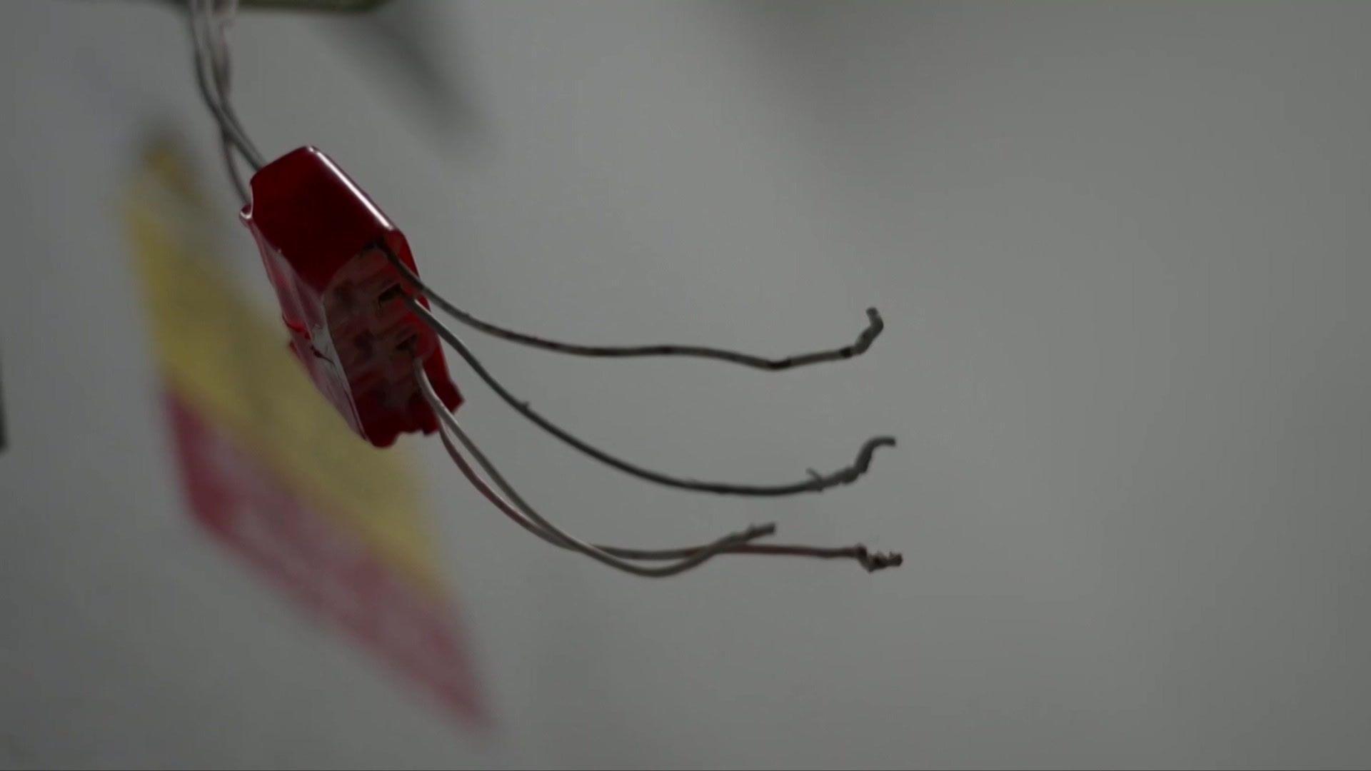 Image shows a close up of some broken, exposed wiring in the flats.