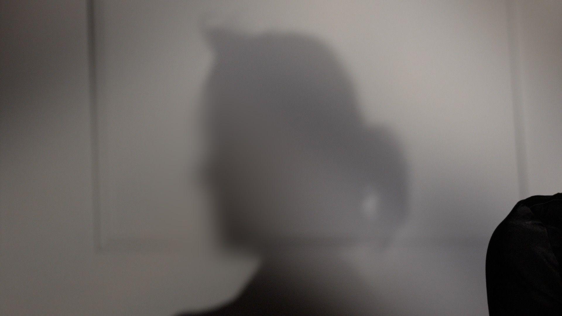 The shadow of Emma’s head and shoulders is cast against a pale wall. Her face and identifying features are not visible.