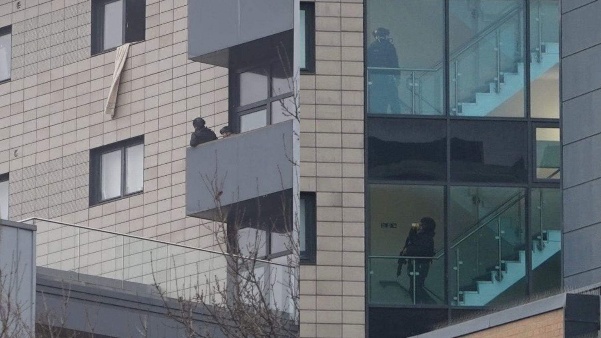 Armed police standing on a balcony in the picture on the left and climbing stairs inside the building on Broad Street in the right hand picture.