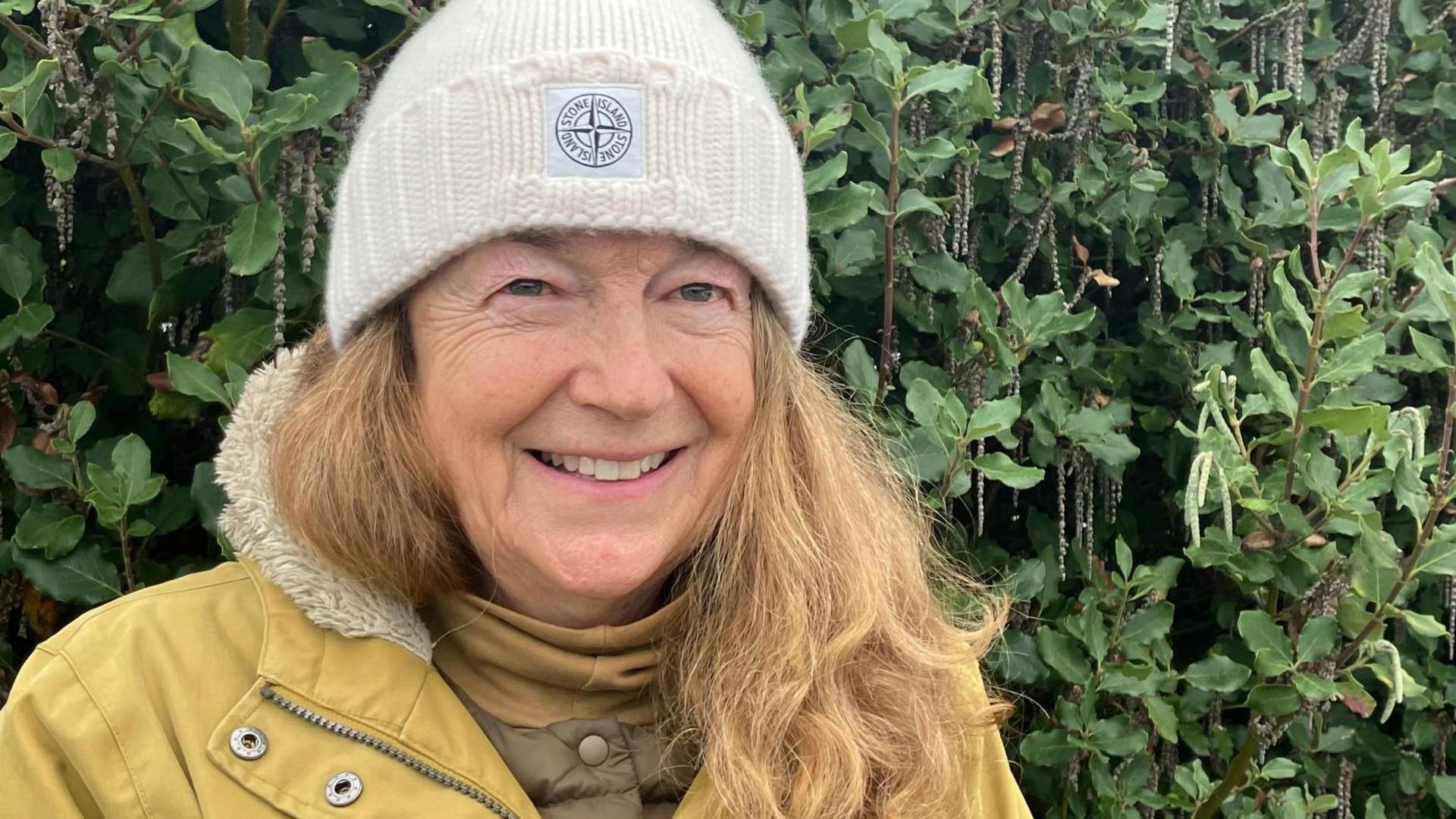 Fiona Gilmore wearing a woolly hat and a yellow coat 