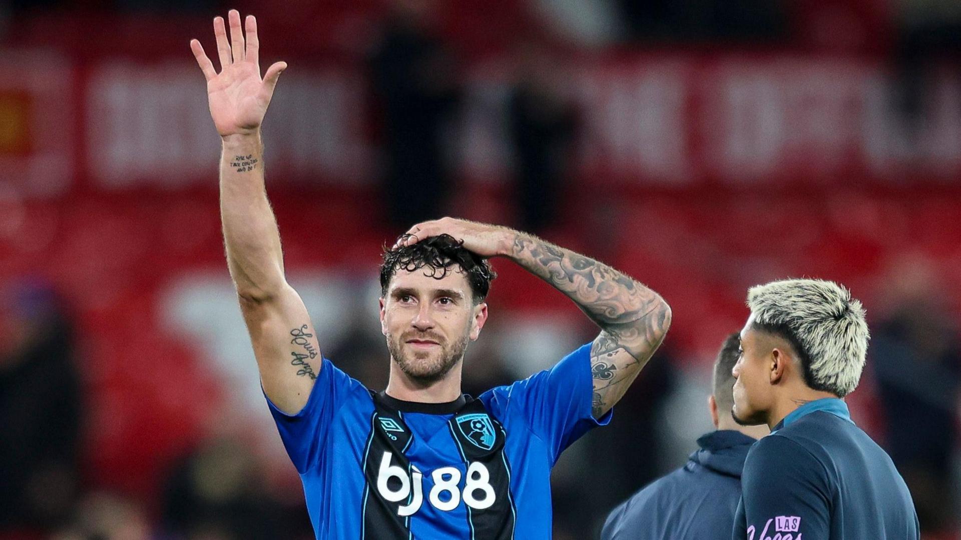 Marcos Senesi waving to the crowd after taking part in a 4-4 draw at Old Trafford against Manchester United