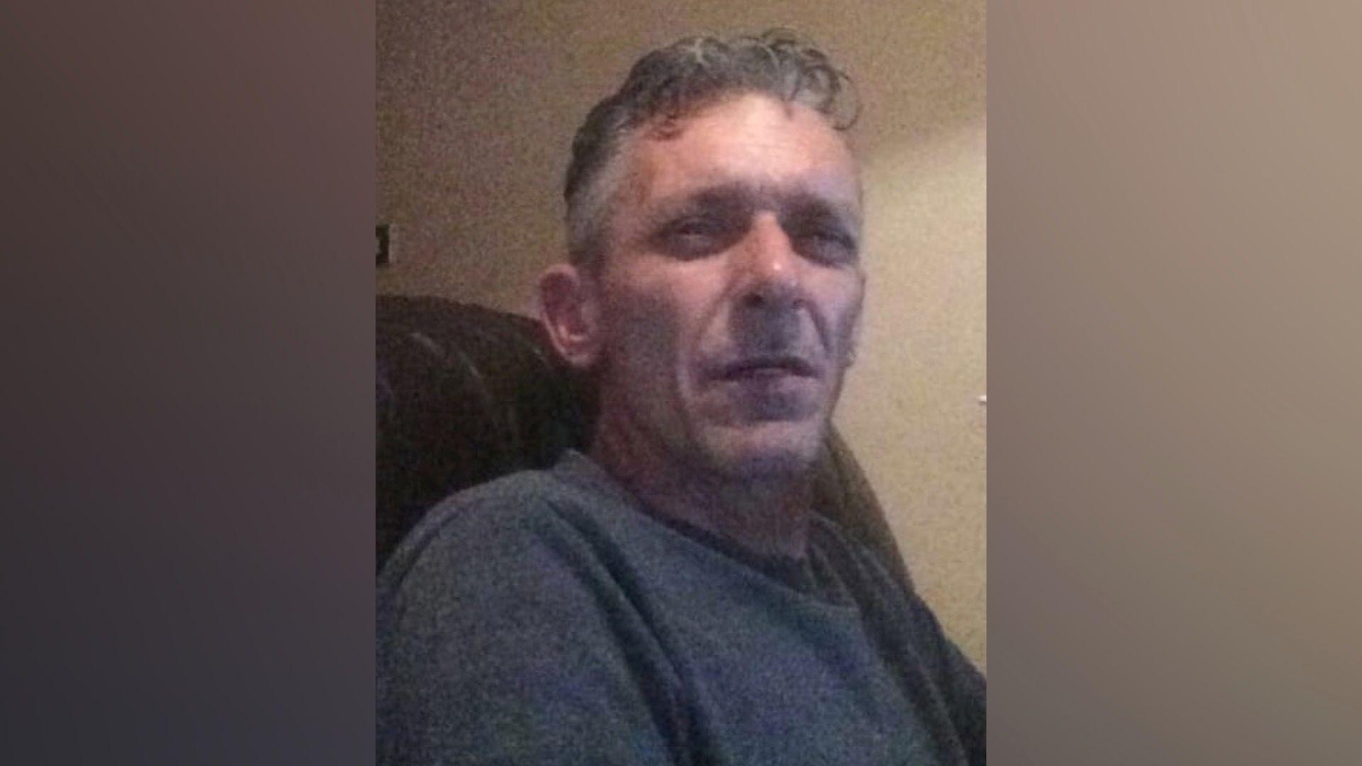 A 58-year-old white male wearing a grey jumper.
