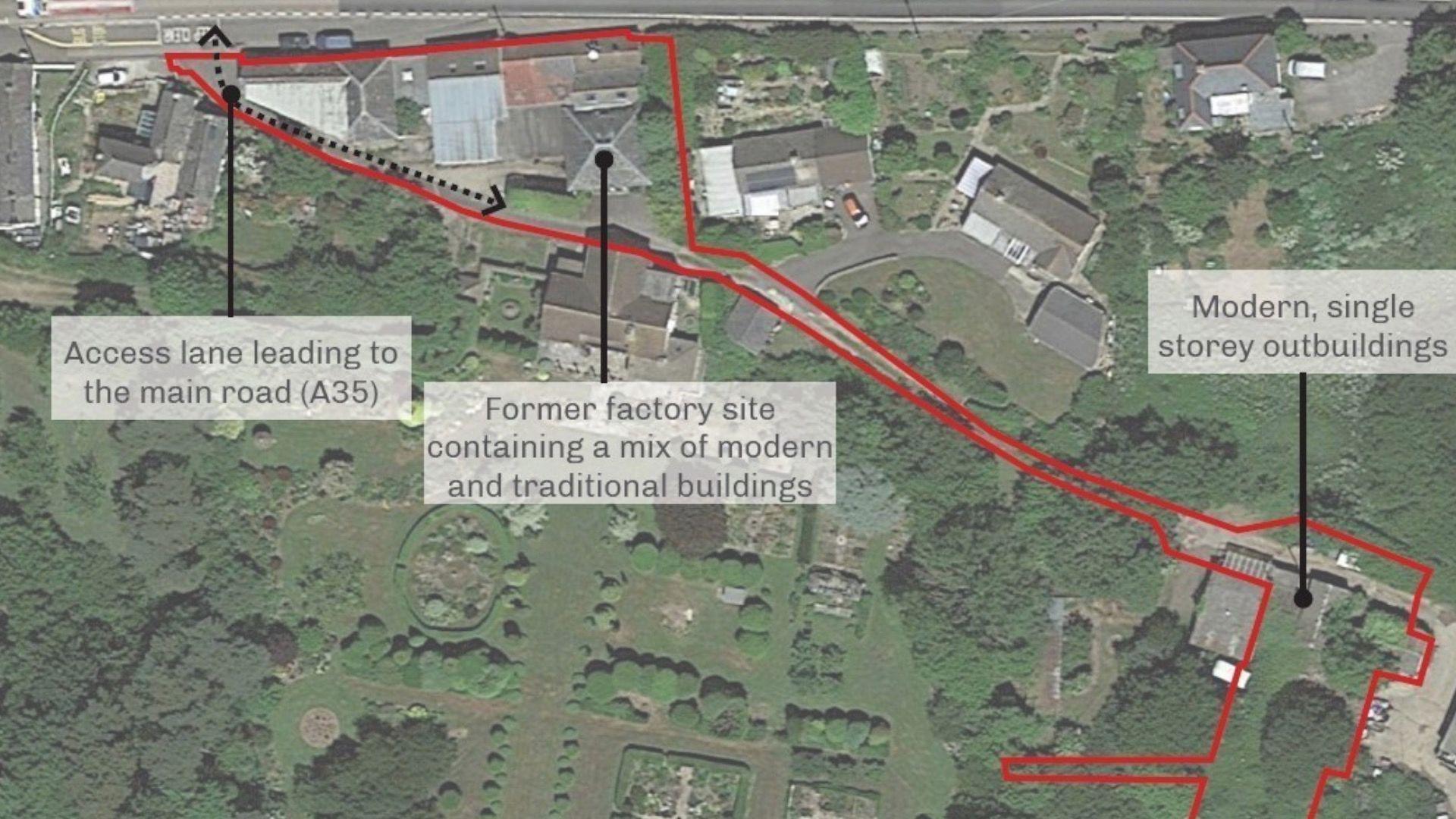 An aerial view of the site. The image mostly shows green areas, with a short row of houses and a red line outlines the proposed renovation area. There are arrows highlighting particular sections of the diagram. From left to right it says access lane leading to the main road (A35), former factory site containing a mix of modern and traditional buildings, modern single storey outbuildings.