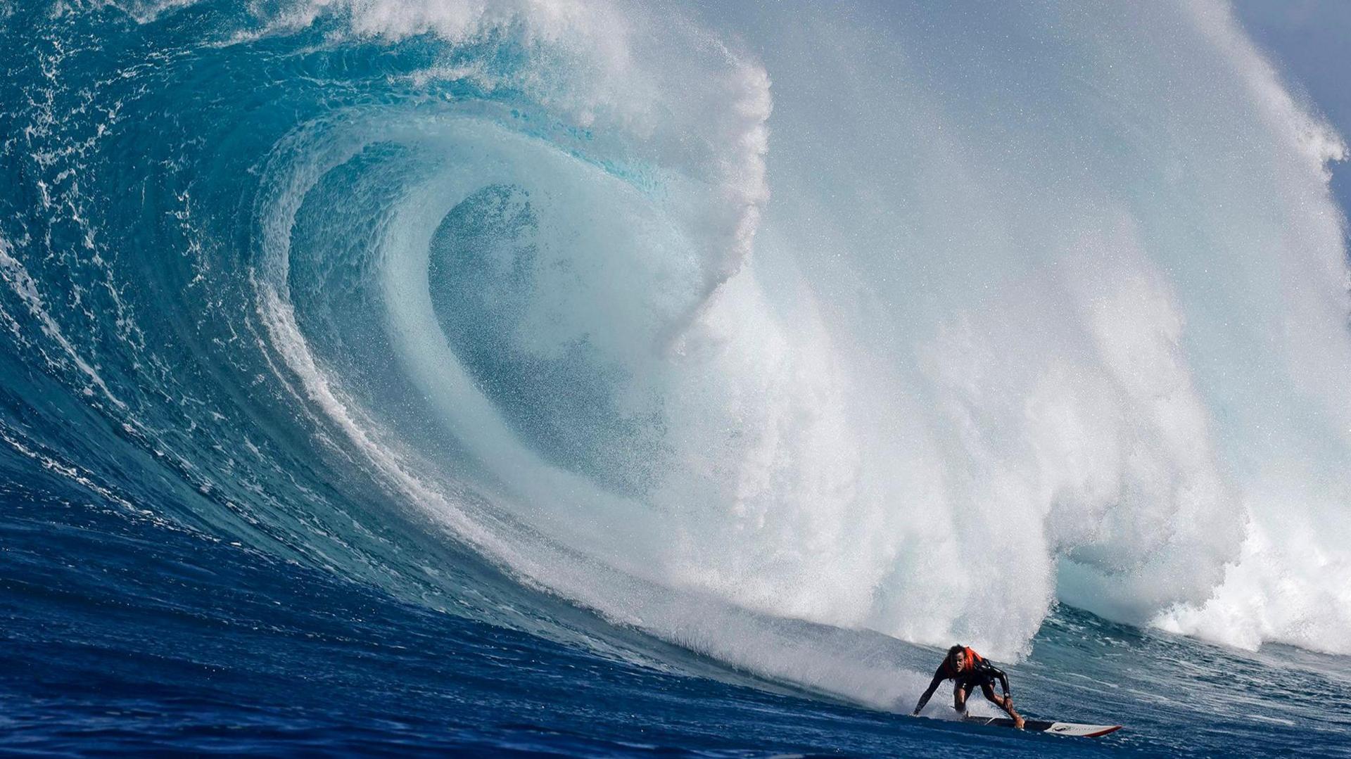 Hawaiian surfer Noah Beschen catches a wave at the Pe'ahi Jaws Surf Break on the island of Maui, Hawaii