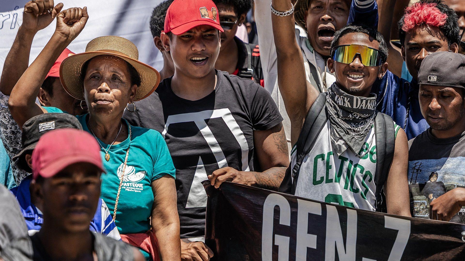 Residents and protesters cheer and hold banners as they gather for a civil society rally outside City Hall in Antananarivo, on Monday.
