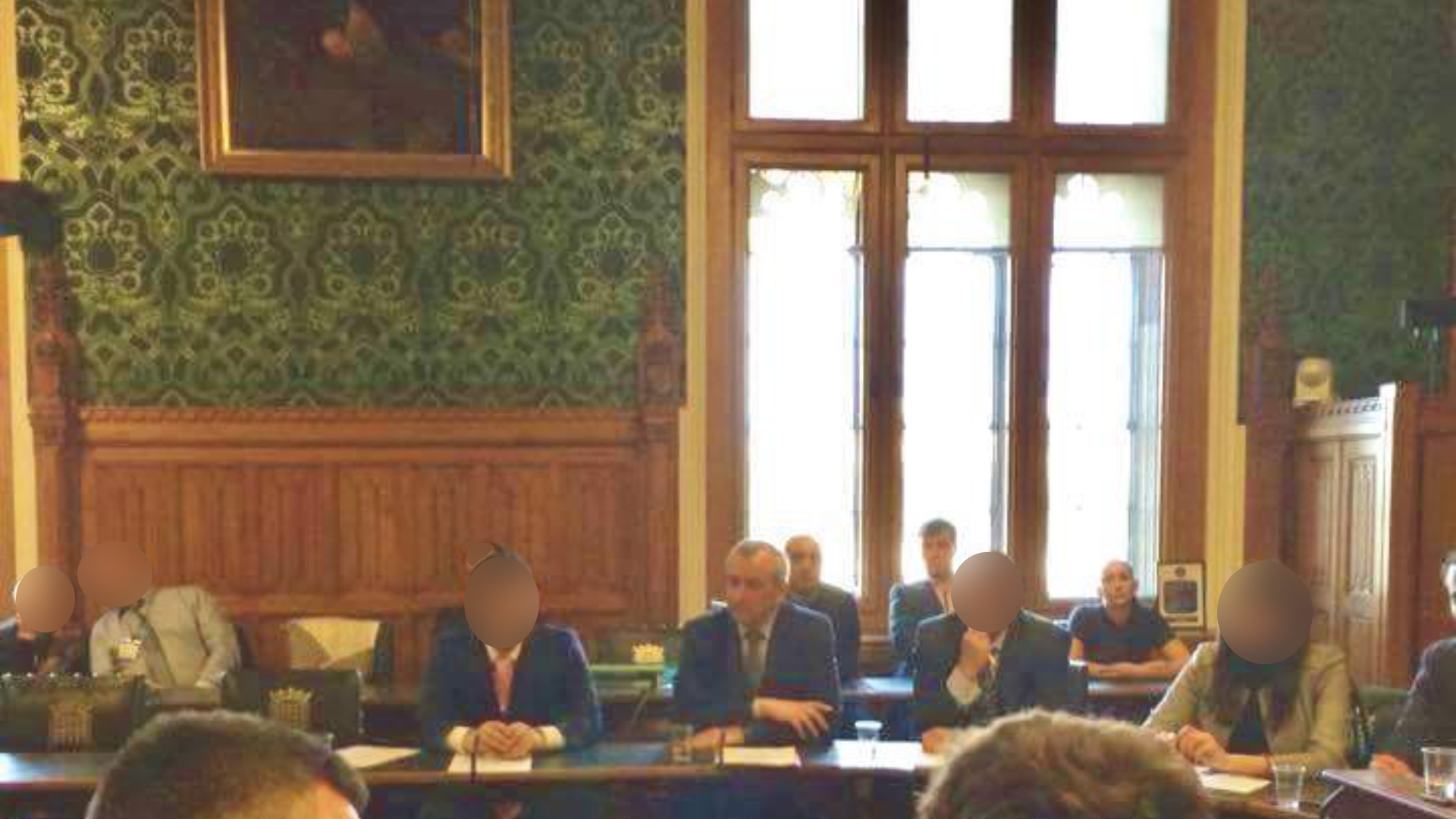 Three convicted spies, sat behind a former Bulgarian politician, Georgi Pirinski, at an event in the House of Commons