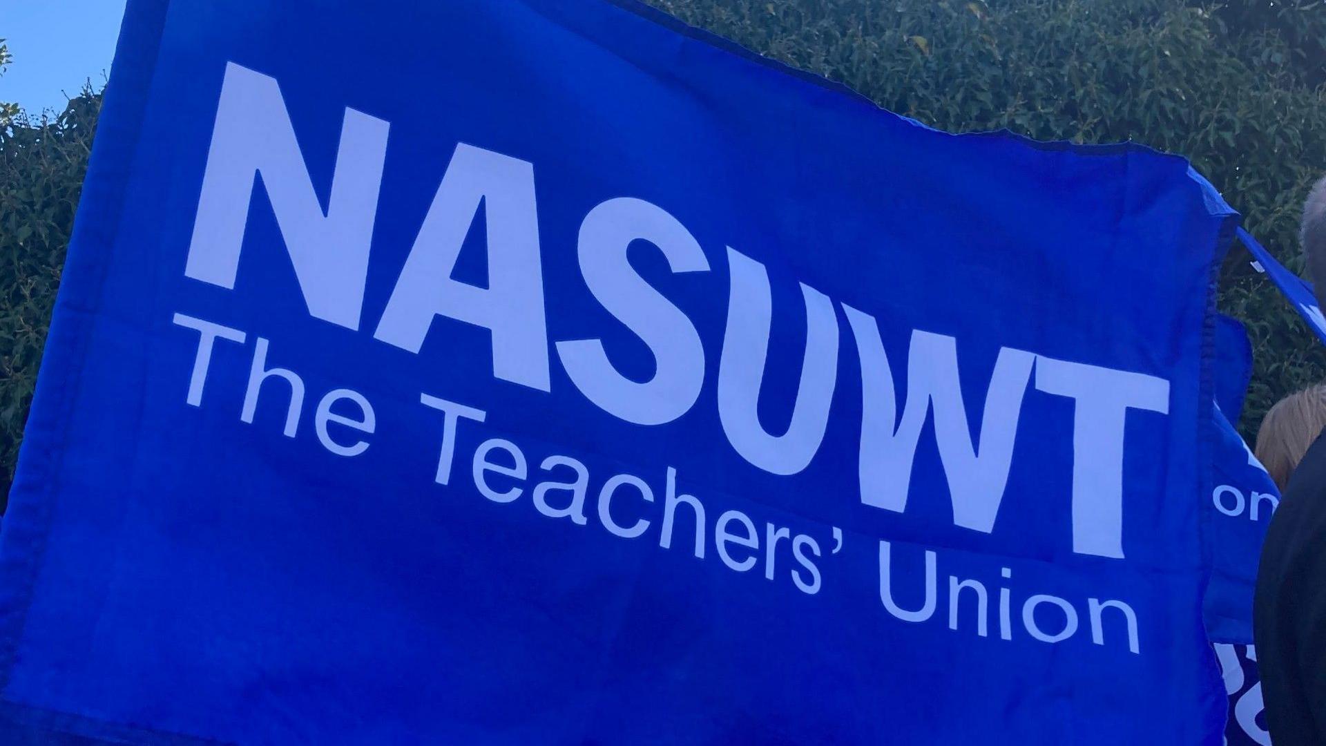 A blue banner with white text reading NASUWT, the teachers' union.