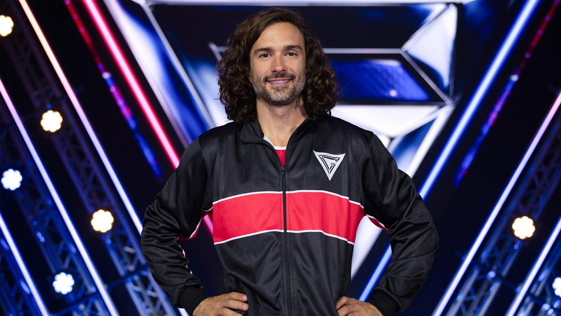Fitness coach Joe Wicks smiles in the Gladiators studio