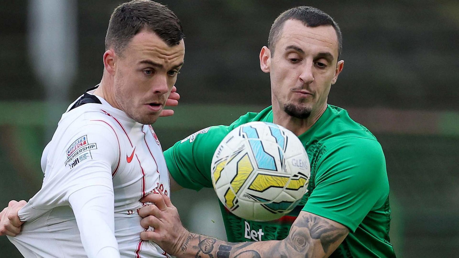 Larne midfielder Chris Gallagher and Glentoran's Dylan Connolly tussle for the ball