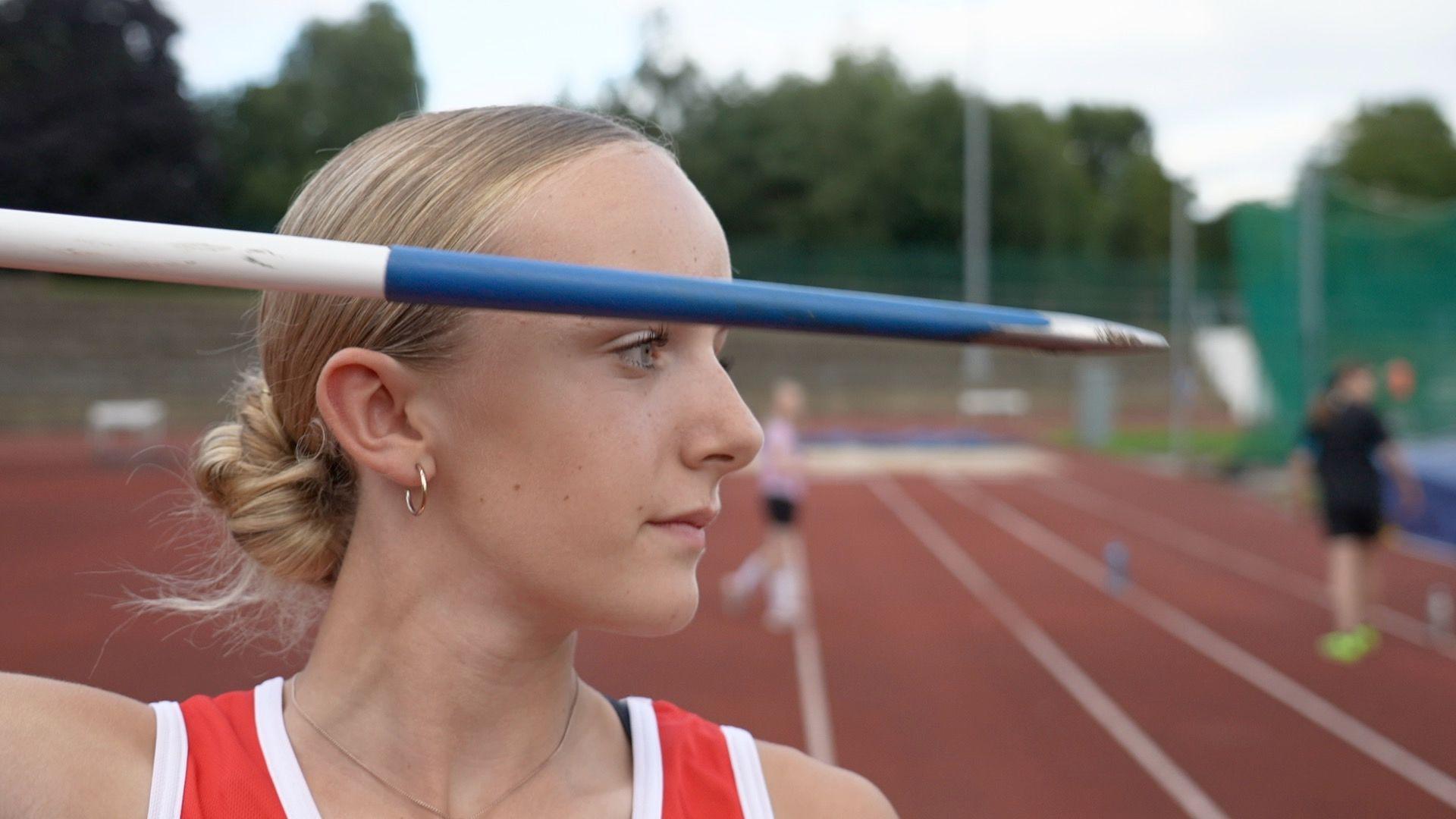 A woman throws a javelin a Yeovil Recreation Centre