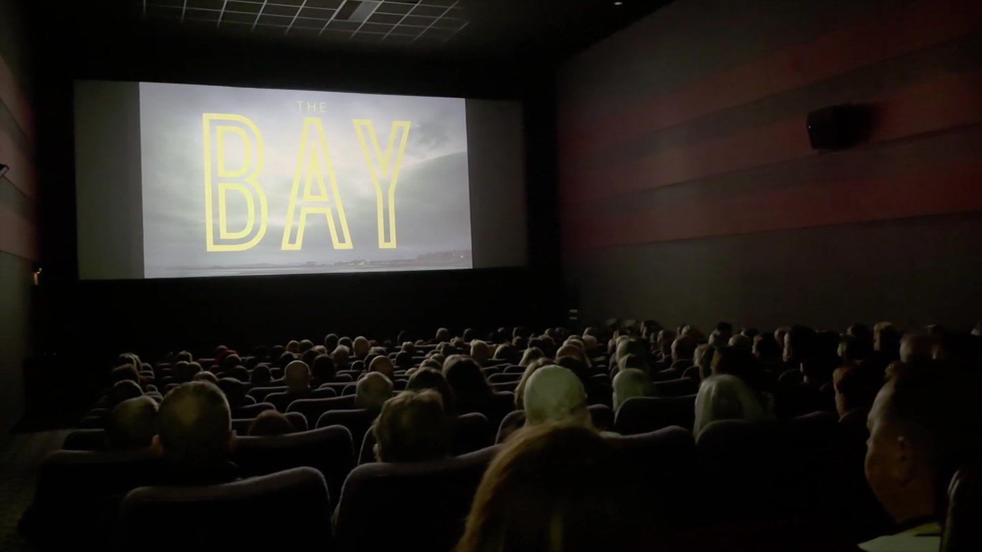 An interior shot of a cinema of people watching a screening of The Bay