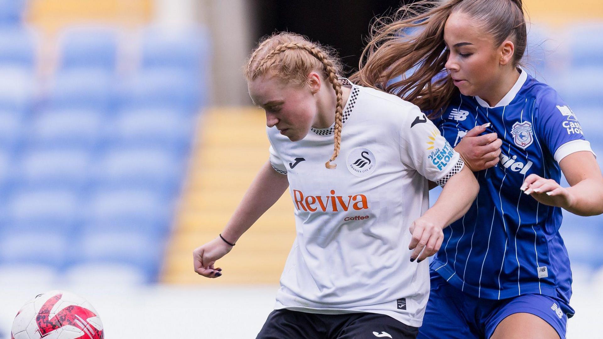 Swansea's Eilish Mitchell battles for possession with Maddison Perrott of Cardiff City