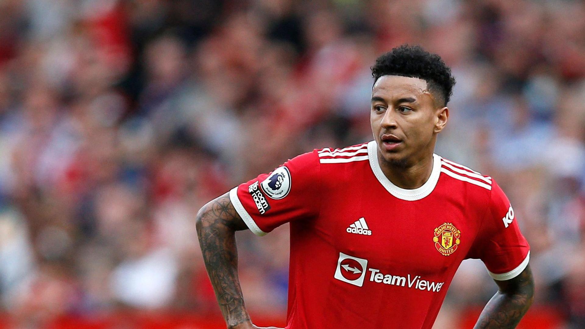 Jesse Lingard when he played for Manchester United, wearing the team's kit with his hands on his hips as they played Norwich City at Old Trafford on 16 April 2022.