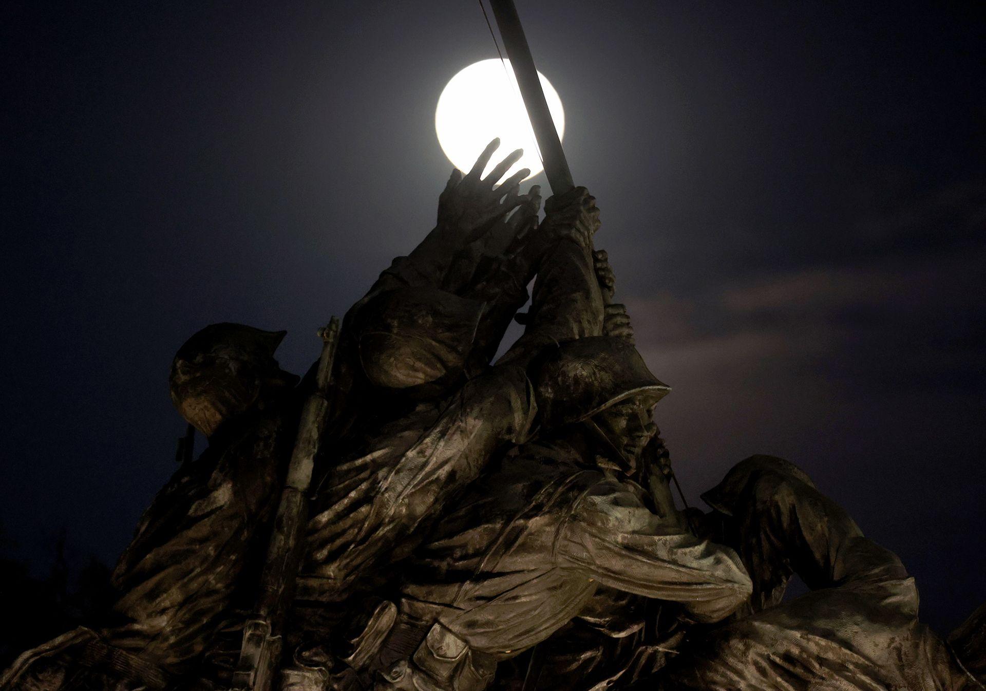 The full moon is seen behind the United States Marine Corps War Memorial, known as the Iwo Jima Memorial in Arlington, Virginia, on November 5, 2025.
