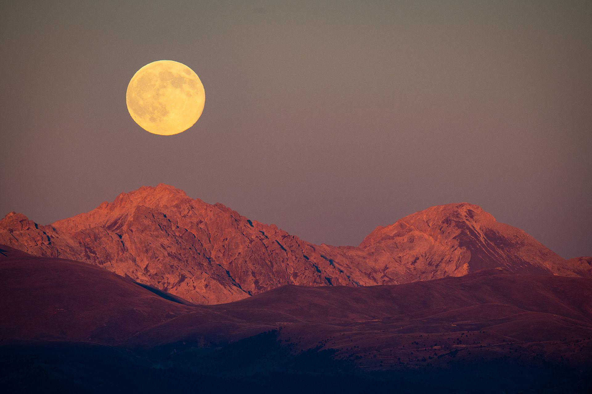 Beaver full moon rising behind Monte Prena and Monte Camicia peaks is seen from L'Aquila, Italy, on November 5th, 2025. 