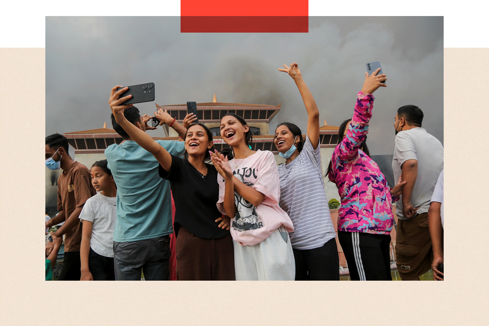 People celebrate and take pictures after occupying Nepal's Parliament building in Kathmandu