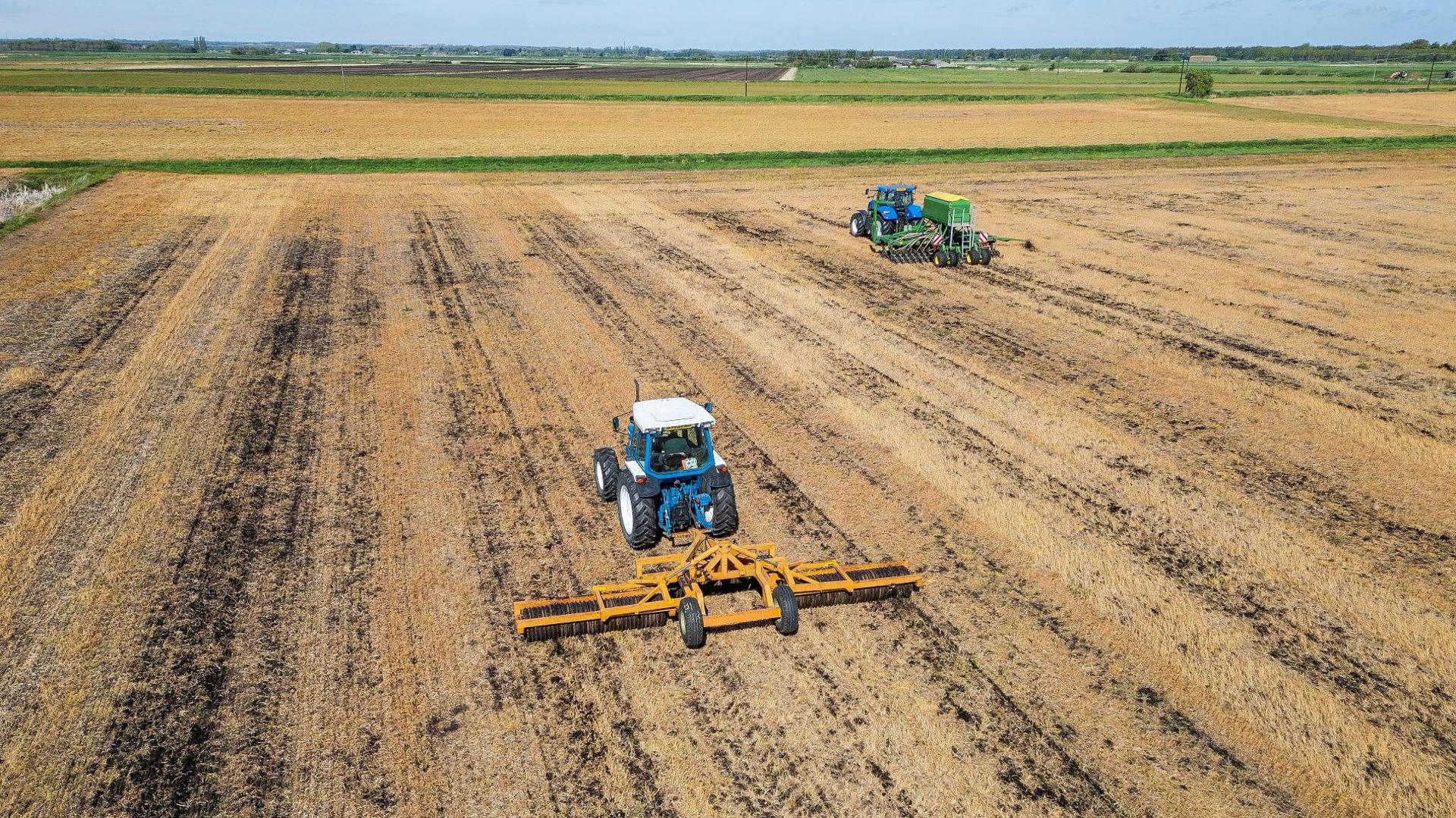 Tractors sowing seeds