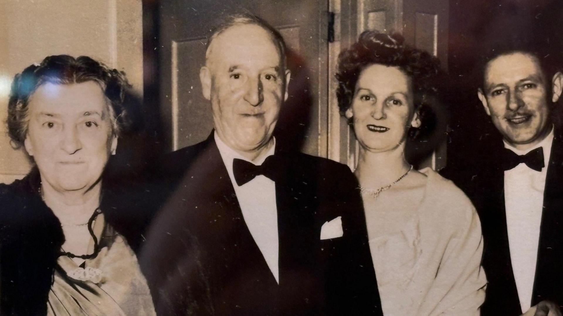 Taken in the late 1950s, the image shows founder Billy Jackson, in a tuxedo, with other family members