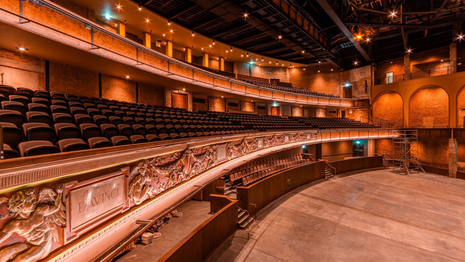 An internal shot of Bradford Live showing curving rows of red seats spread across three levels