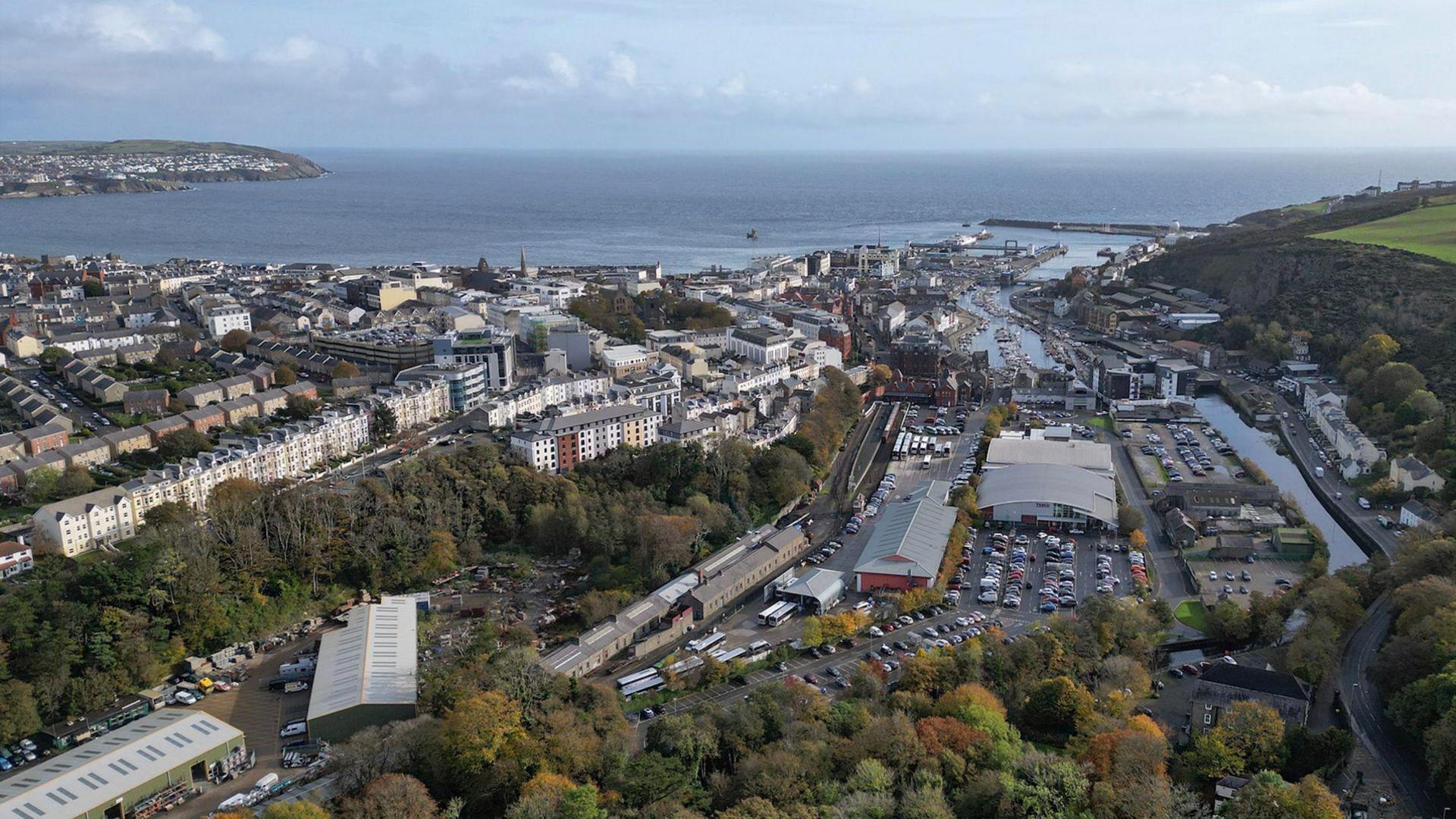 An expanse of rooftops across Douglas, with the bay in the background and Onchan Head to the left.