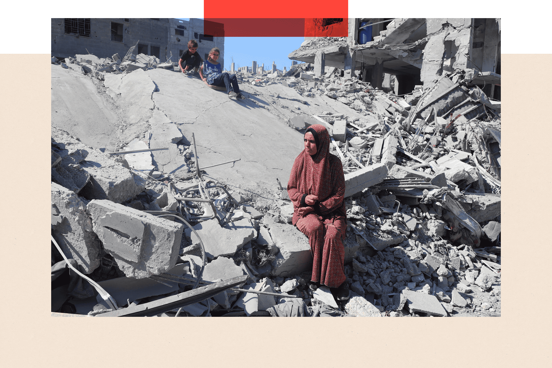 A displaced Palestinian woman and her children sit on the rubble of homes destroyed during an Israeli strike in October 2025