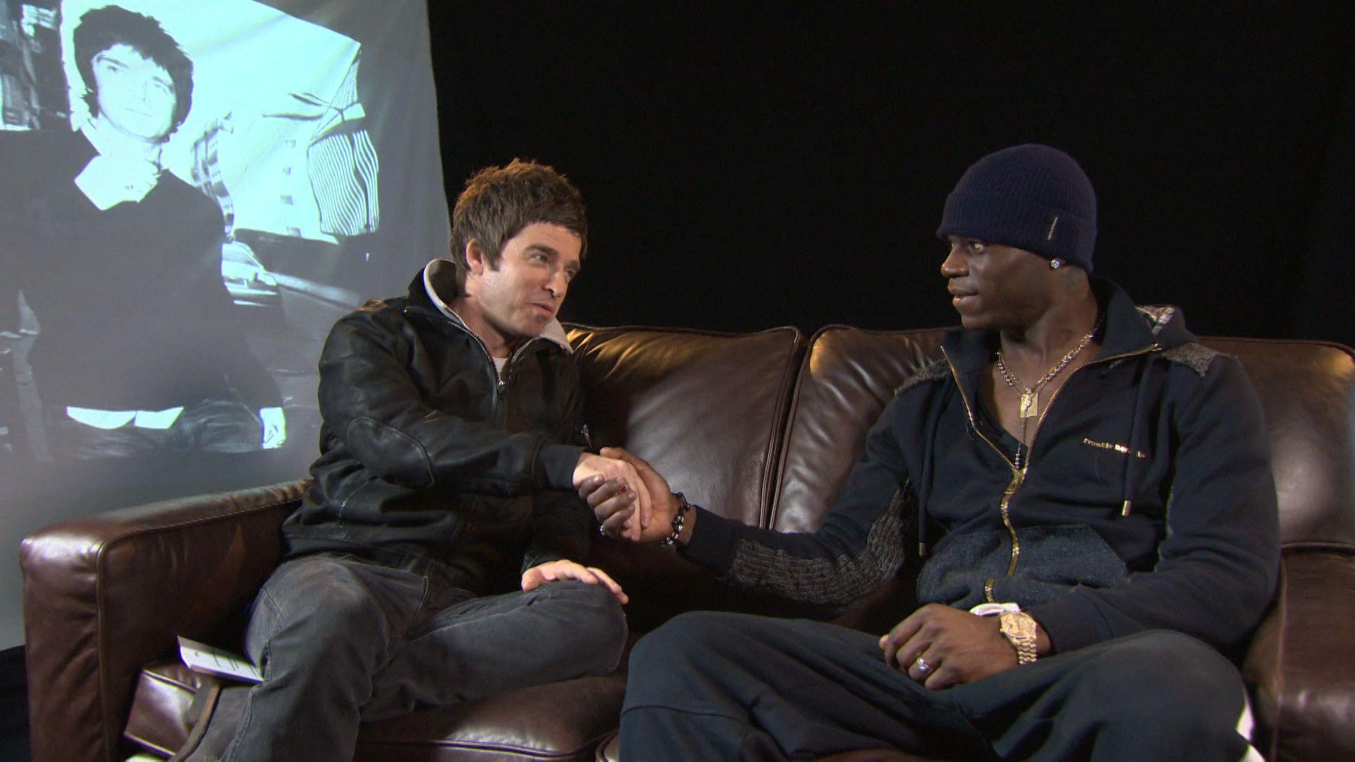 A picture of Noel Gallagher sitting on a sofa with Mario Balotelli