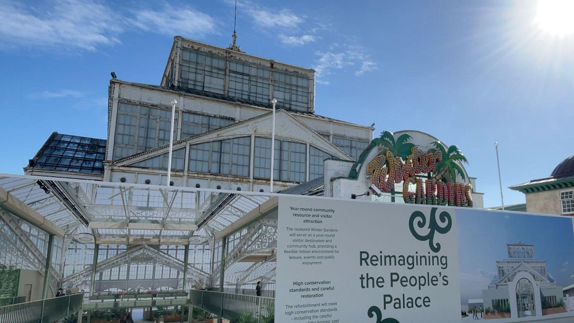 The outside of the Winter Gardens in Great Yarmouth, Norfolk. On the front of the building is a sign which previously used to illuminate. The sign which also has palm trees on it reads, Winter GARDENS.