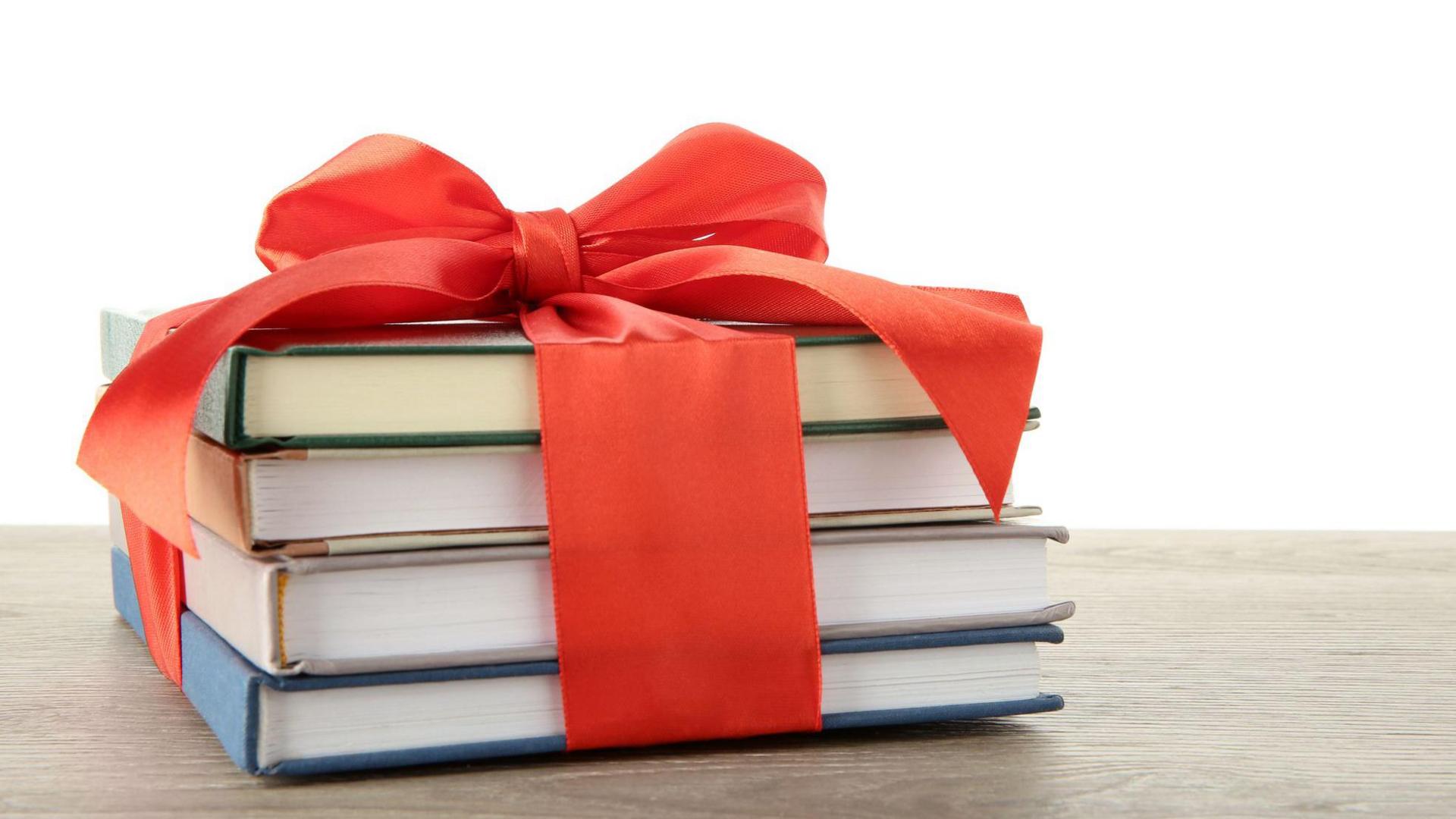 Stack of books with red ribbon.