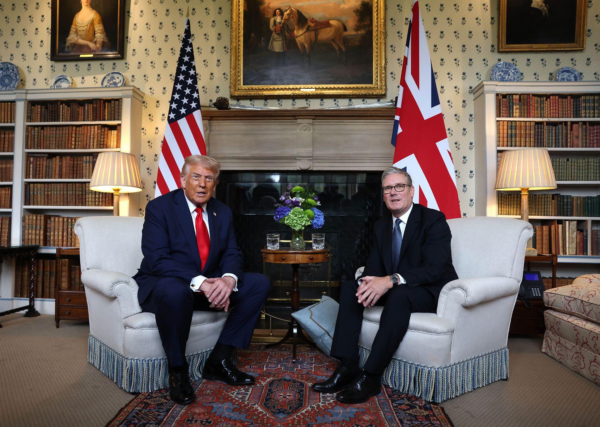 British Prime Minister Keir Starmer (R) and US President Donald J. Trump (L) seen sitting next to each other, looking straight into the camera ahead of their bilateral meeting in Chequers