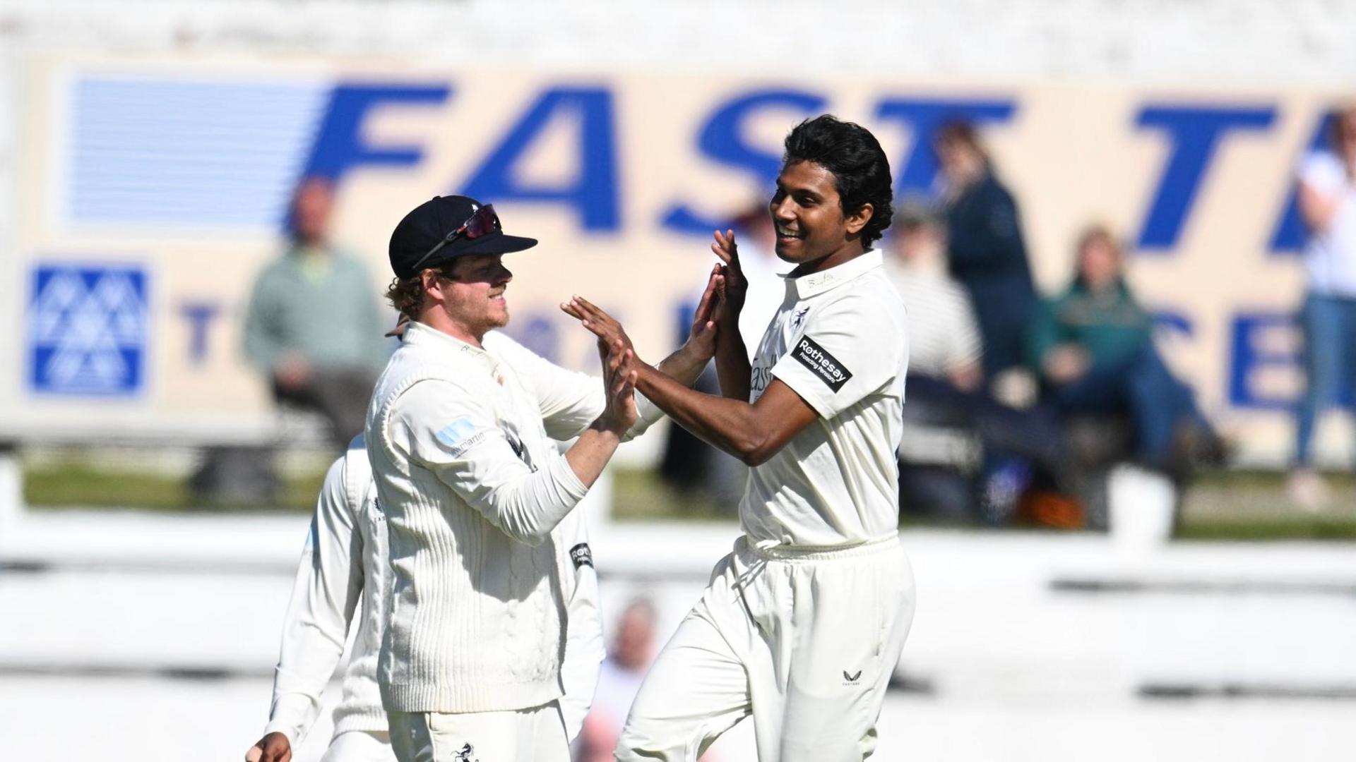 Hasan Mahmud (right) is congratulated by Sam Northeast (left) after taking a Lancashire wicket at Blackpool