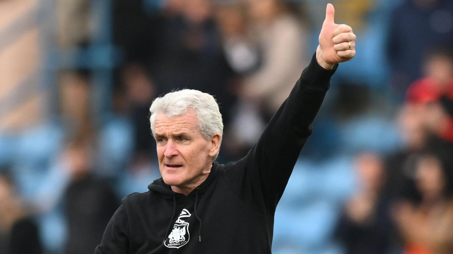 Carlisle United manager Mark Hughes gives the thumbs up