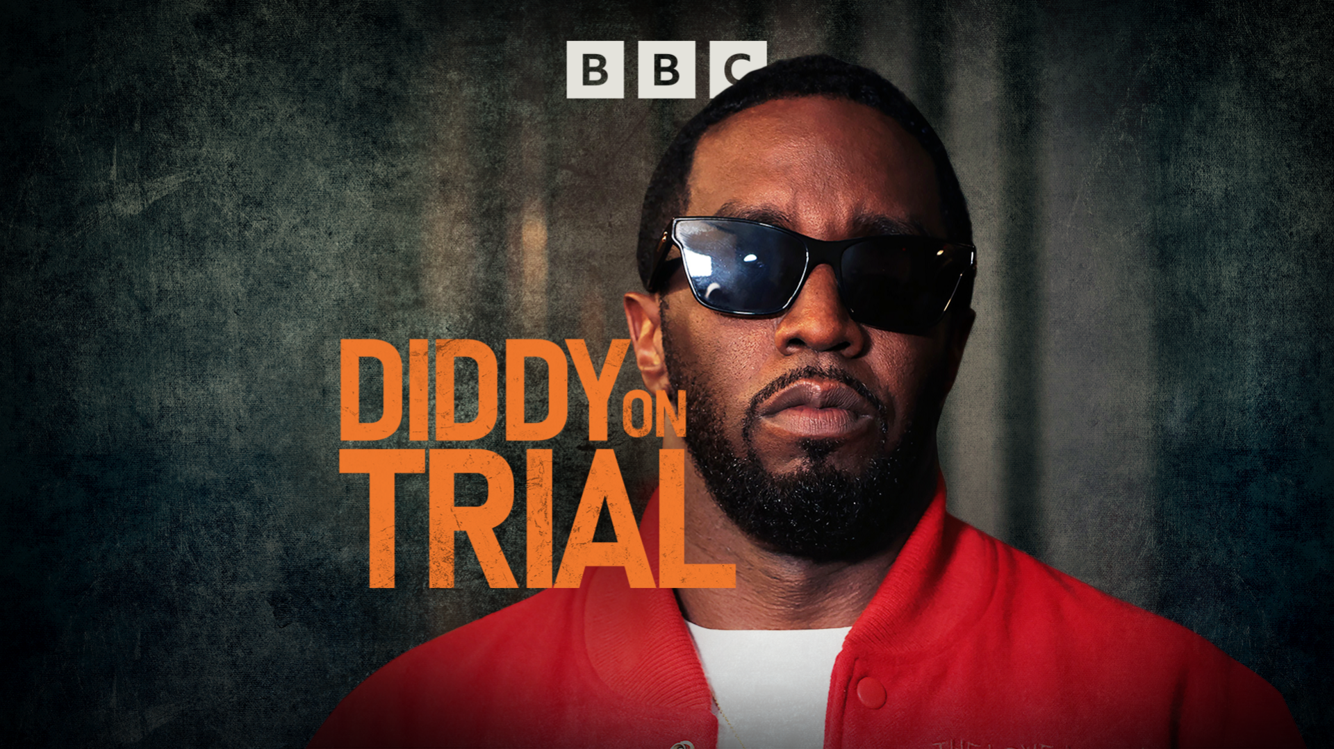 Headshot of Sean "Diddy" Combs looking into the camera, wearing sunglasses. The words "Diddy on Trial" are written in orange next to his head.