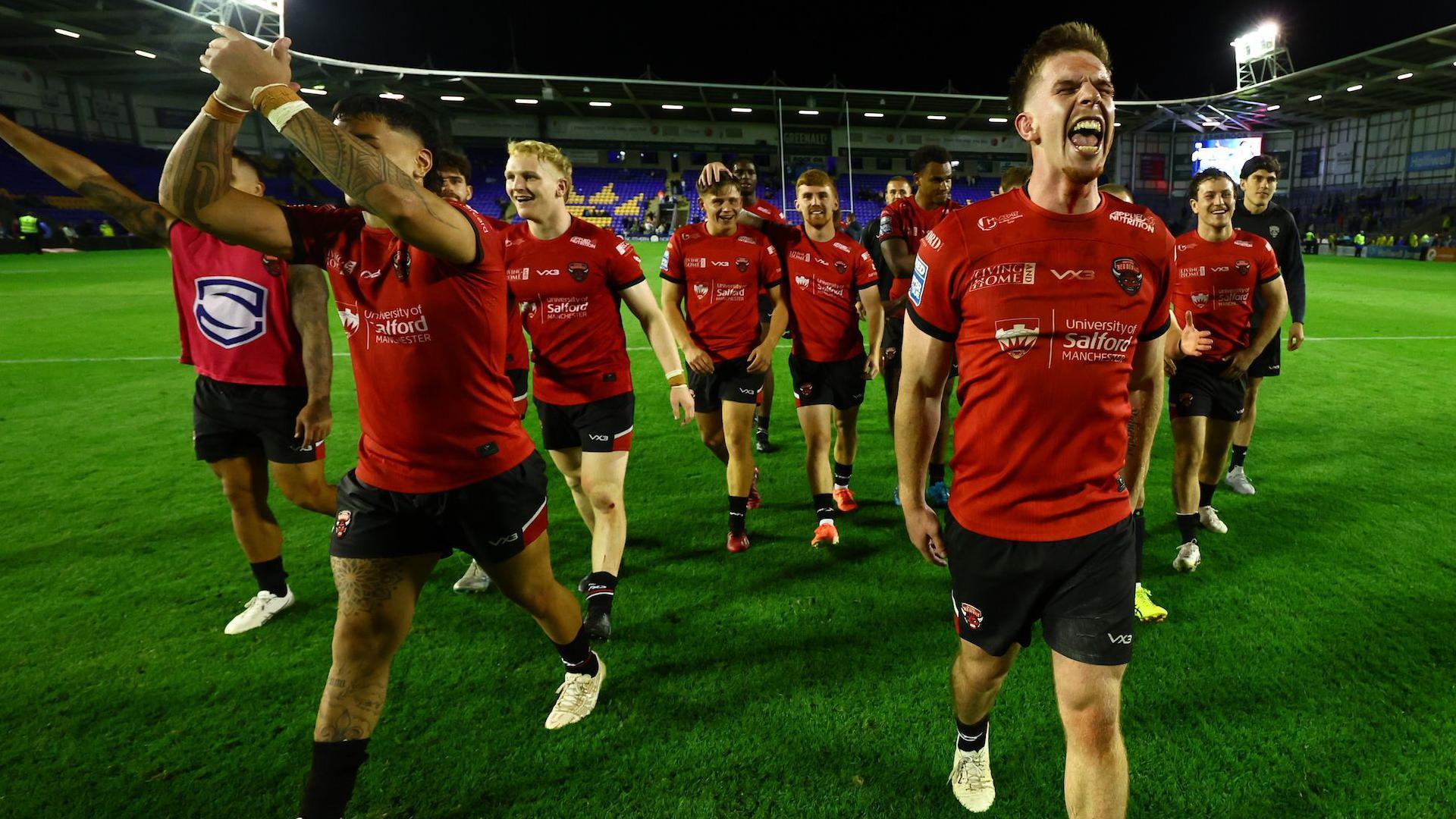 Salford Red Devils celebrate beating Warrington Wolves