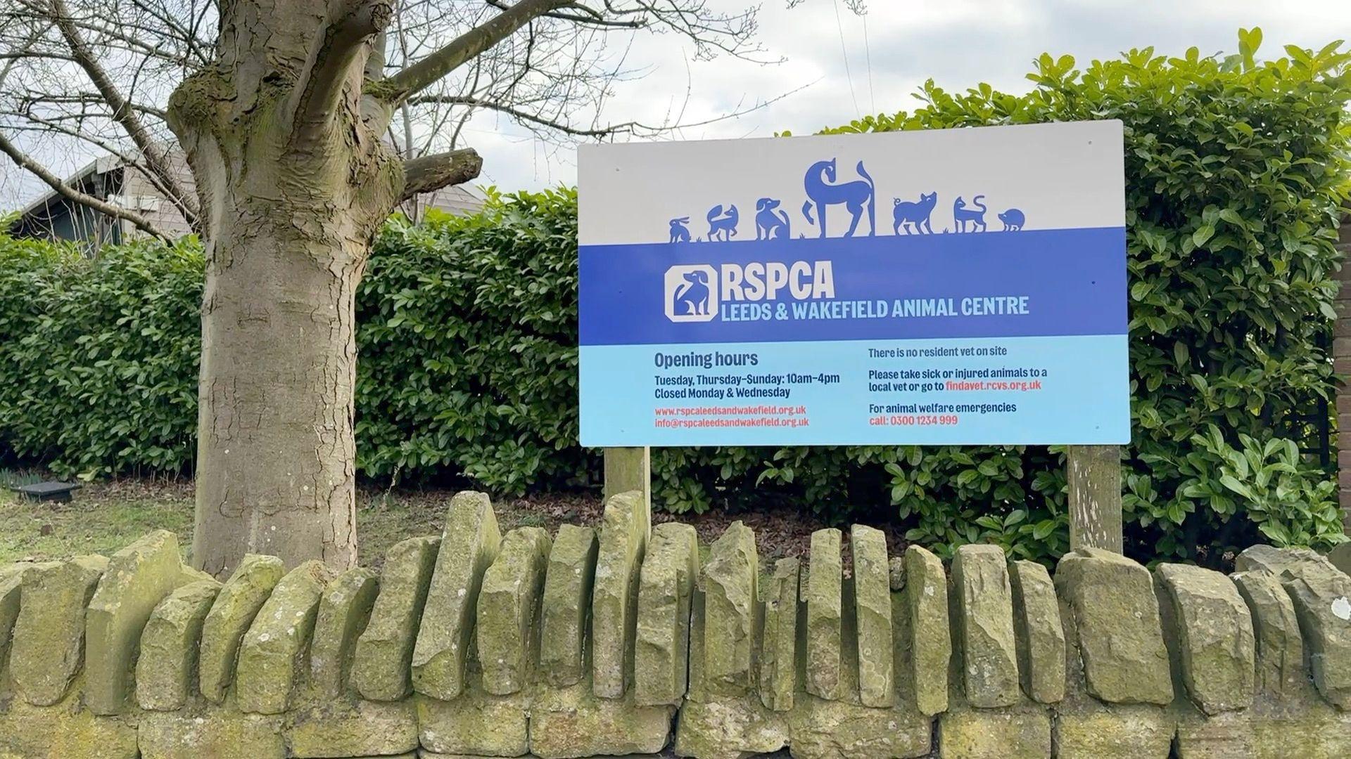 A blue sign reading RSPCA Leeds and Wakefield Animal Centre, placed outside the centre.