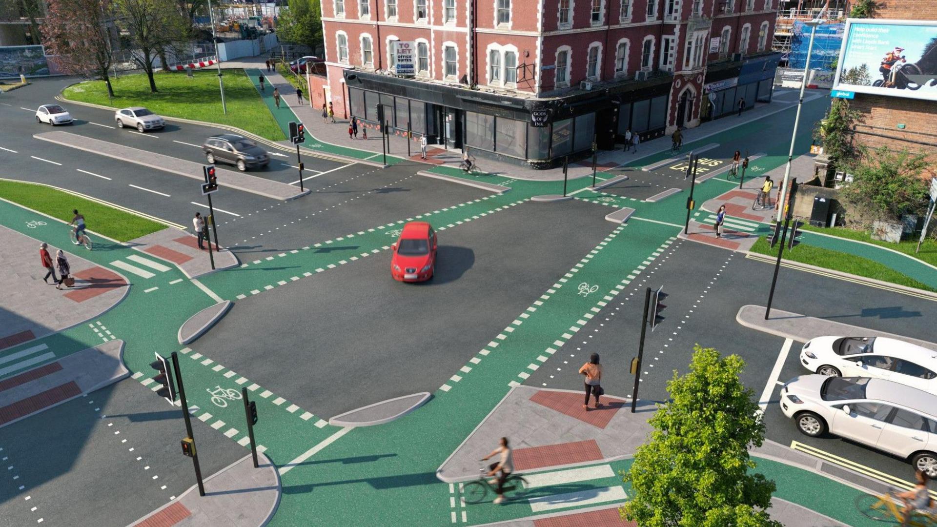 A computer generated image showing a junction in a city centre. There are four roads at the traffic light junction, with a bus lane between two buildings at the top and the other three roads holding regular traffic. Green cycle lanes border the central part of the junction, which a red car is making its way across, and pedestrians can be seen waiting at the lights to cross.