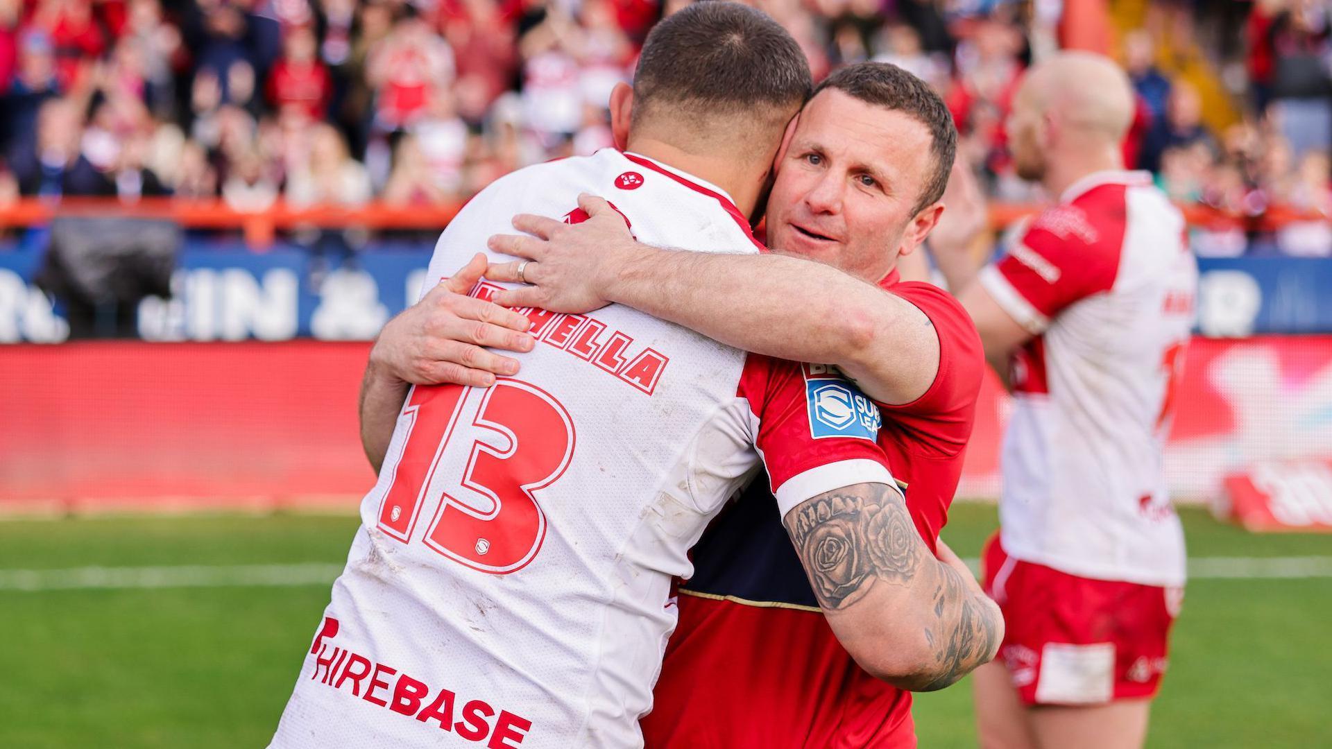 Elliot Minchella embraces boss Willie Peters in a hug after Hull KR got the better of St Helens in the early rounds of Super League in 2024.