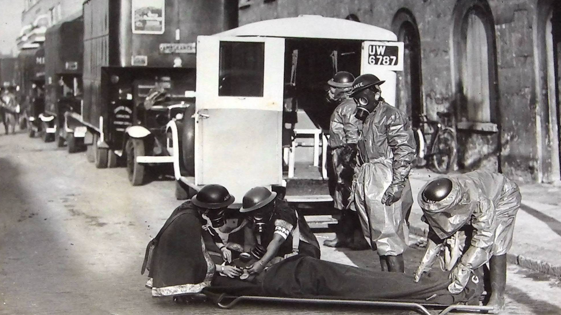 Women completing casualty training in gas masks during World War II