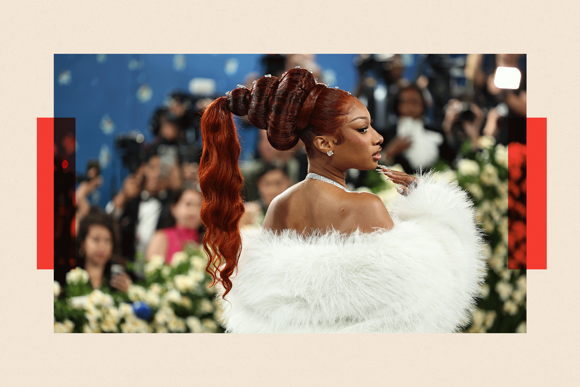 Megan Thee Stallion wearing white stole pictured from behind on a red carpet