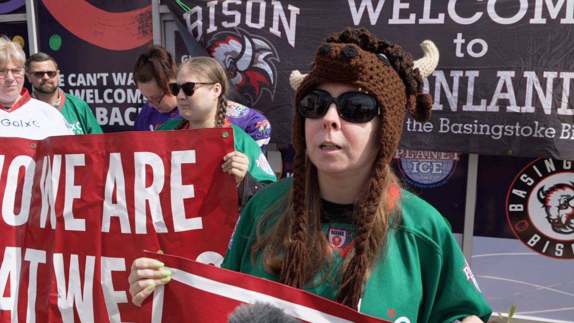 A Bison ice hockey fan wearing a horned hat and team colours celebrates the news the team will return next season