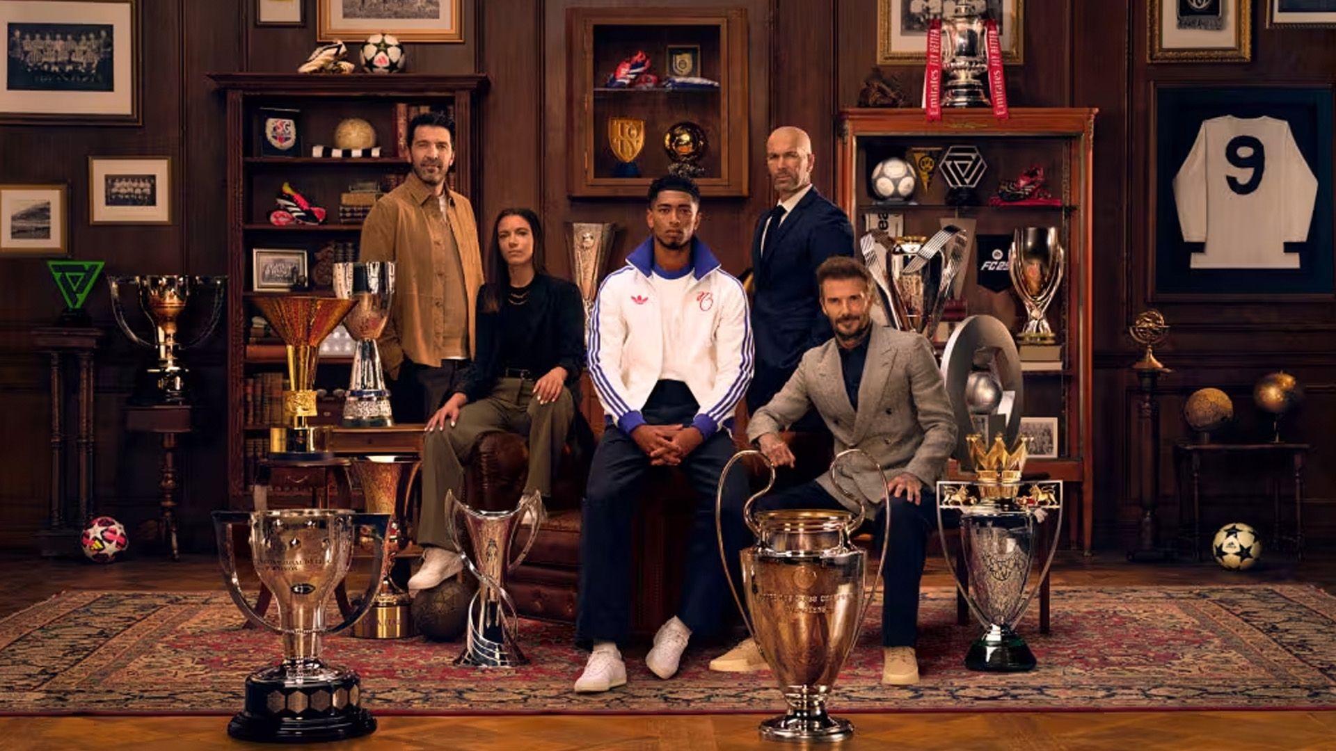 football players sit together with lots of trophies