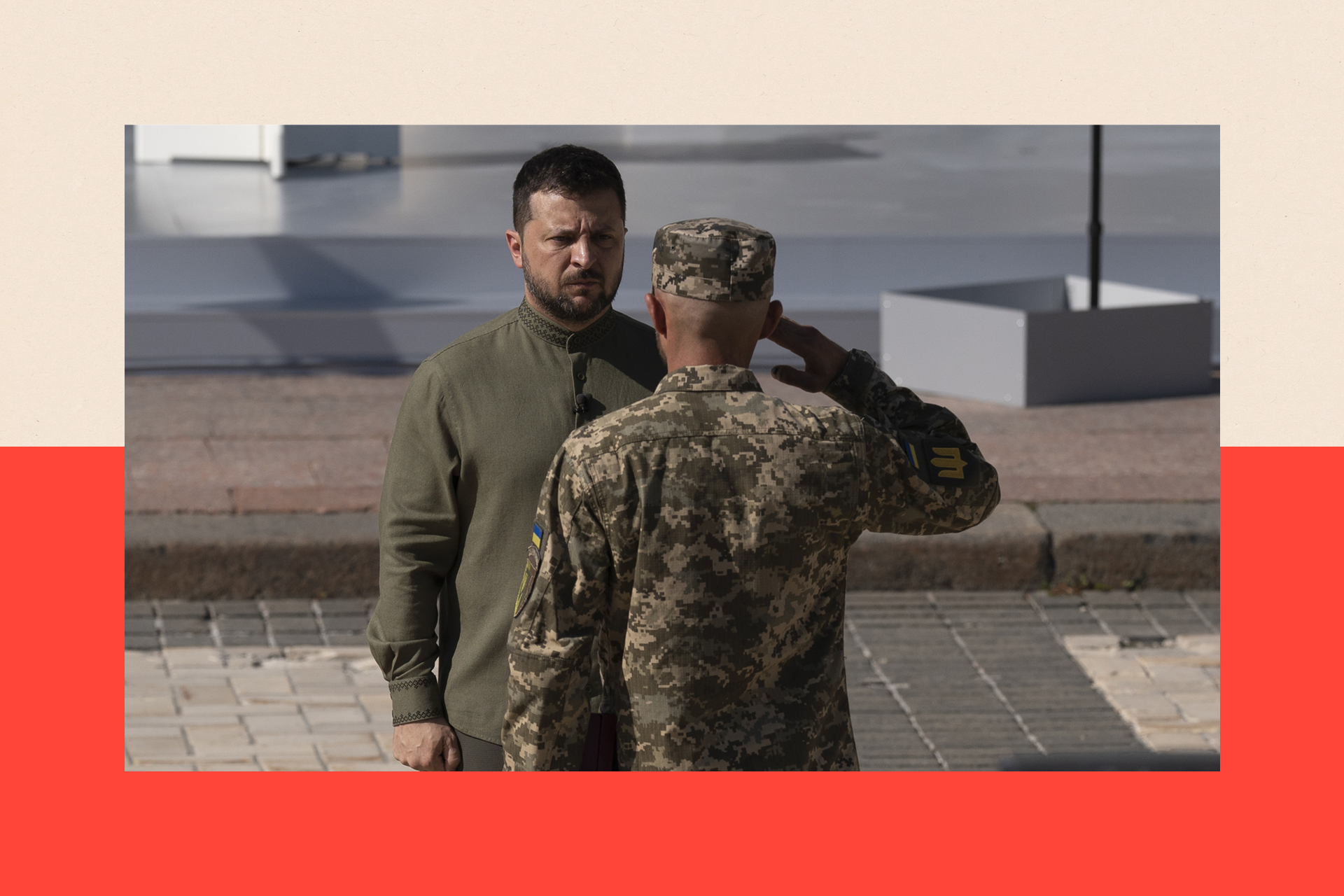 Volodymyr Zelensky receives a salute from a Ukrainian soldier
