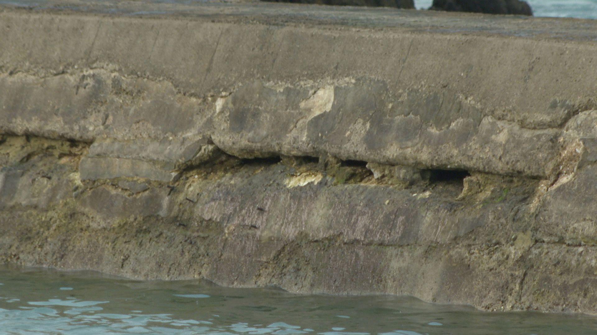 Cracks in the side of the Hope Cove Harbour breakwater.