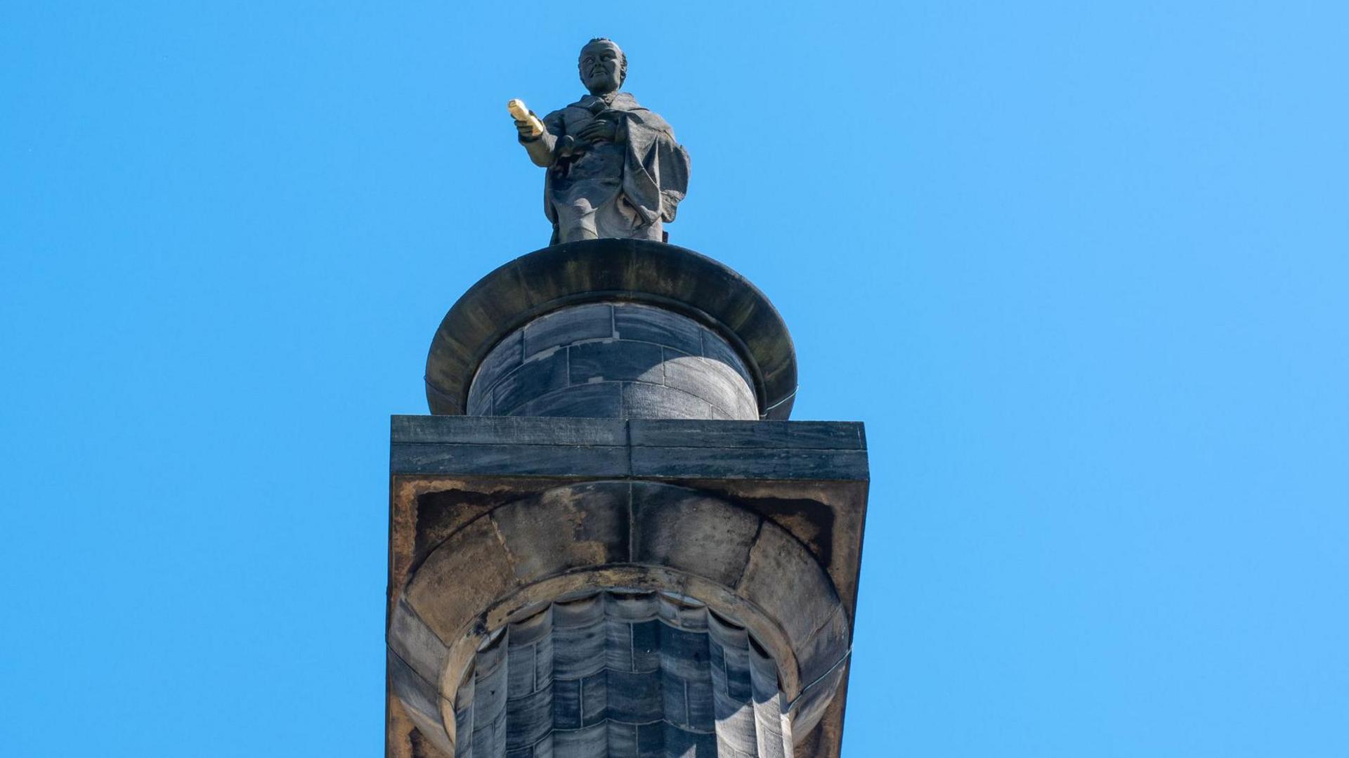 A view of the grey-coloured Wilberforce Monument in Hull, which is topped by a statue of William Wilberforce